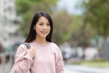 Poster - Woman smile to camera and stand on the street