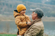 © Westend61 - Grandfather carrying grandson wearing warm clothing