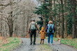 © Westend61 - Boy with grandparents and dog walking on footpath in forest