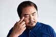 © 9nong - Portrait of visual-impaired asian man with eye irritation or eye inflammation