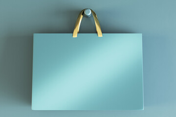 Poster - Shopping or present concept with front view on blank blue craft bag with golden handles and place for company logo or advertising text on light turquoise wall background. 3D rendering, mockup
