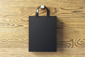 Poster - Shopping or present concept with front view on blank dark craft bag with silver handles and space for company logo or advertising text on wooden wall background. 3D rendering, mock up