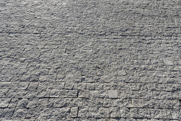 Wall Mural - The texture of a stone old pavement with a perspective.