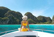 Rear view of tourist woman sit on the sailing boat luxury travel southeast asia on summer vacations Maya beach Ko Phi Phi