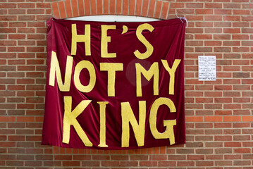 Opposition to King Charles coronation. He's not my king banner on the side of a house with a hand written note why.