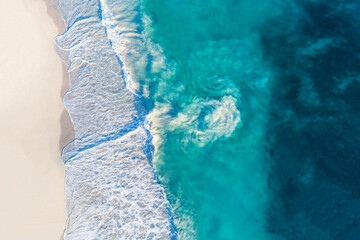 Wall Mural - Aerial view of sandy beach with waves and riptide current. Sunny day in summer with transparent tropical blue water. Travel to Alkimos Beach, Western Australia, Australia. Top view. Coastal, Seascape