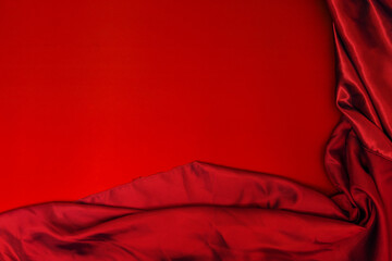 A blood red satin fabric on a smooth