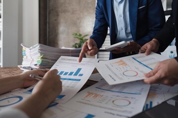 Canvas Print - Business team using a calculator to calculate the numbers of statistic business profits growth rate on documents graph data, desk in the office, teamwork process