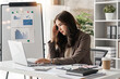 © Natee Meepian - tired business woman sleepy and bored from sitting at a desk for a long time and has office syndrome