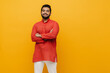 © Drobot Dean - Young indian man smiling while standing with folded arms isolated over yellow background