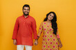 © Drobot Dean - Indian man and woman smiling and holding hands isolated over yellow background