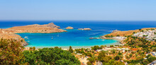 Sea Skyview Landscape Photo Lindos Bay And Castle On Rhodes Island, Dodecanese, Greece. Panorama With Ancient Castle And Clear Blue Water. Famous Tourist Destination In South Europe