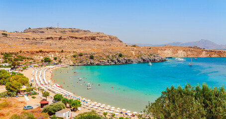 Wall Mural - Sea skyview landscape photo Lindos bay and sea coast on Rhodes island, Dodecanese, Greece. Panorama with nice sand beach and clear blue water. Famous tourist destination in South Europe