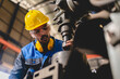 © chokniti - professional business industry technician wearing safety helmet working to maintenance service and checking factory equipment, a work of engineer occupation in manufacturing construction technology
