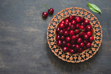 Wall Mural - Composition of sweet cherries on a plate with water drops. Summer and harvest concept. Cherry macro. Vegan, vegetarian, raw food