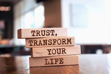 Wall Mural - Wooden blocks with words 'Trust, transform your life'.