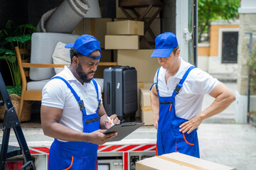 Poster - Two removal company workers are unloading boxes from a mini truck into new home.