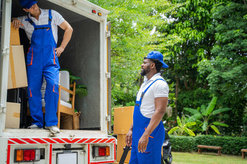 Wall Mural - Removal company workers unloading Boxes From Truck Into New Home On Moving Day.