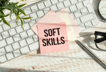 A card with Soft Skills text on wooden background, business concept