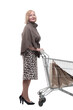 attractive mature woman with shopping cart . isolated on a white
