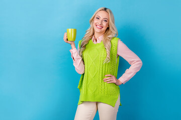 Poster - Photo of young business agent hr manager woman have rest drinking cappuccino hold cup wear stylish vest isolated on blue color background