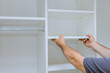 © ungvar - Handyman service in process of assembly and installation for furniture closet cabinet