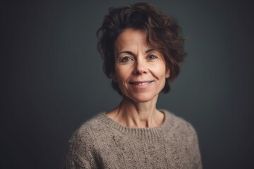 Sticker - Portrait of a beautiful middle aged woman with short hair on a gray background