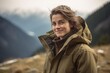© Robert MEYNER - Portrait of a beautiful young woman in a raincoat on the background of mountains