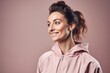 Medium shot portrait photography of a grinning woman in her 30s wearing a comfortable tracksuit against a pastel or soft colors background. Generative AI