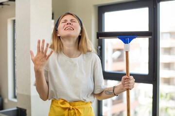 Wall Mural - young pretty woman screaming with hands up in the air. windows washer concept