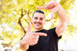 © kues1 - young cool man feeling happy, friendly and positive, smiling and making a portrait or photo frame with hands