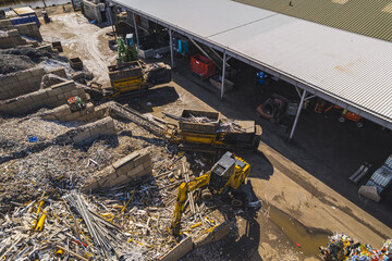 Excavator loading metal or plastic onto conveyor for shredding the scrap and recycling, Netherlands. High quality photo