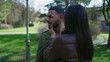 © Marco - Depressed young man being consoled by woman embrace outside at park. Desperate person suffering from mental illness covering face with hand