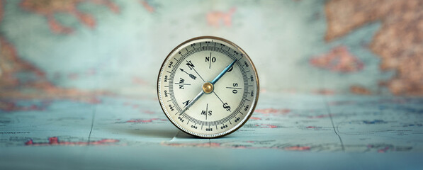 Poster - Magnetic old compass on world map.Travel, geography, navigation, tourism and exploration concept background.