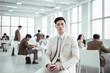 © tiena - Young asian businessman in a modern white office