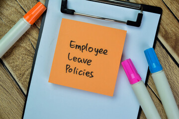 Wall Mural - Concept of Employee Leave Policies write on sticky notes isolated on Wooden Table.