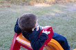 © Lore Poleto - Child playing in the playground. Kid having fun sliding. Boy playing on the slide.