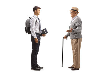 Sticker - Full length profile shot of a grandfather talking to a male teenage student in a school uniform