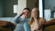 © stockbusters - Couple holding keys new house sitting on couch close up. Family rejoicing home.