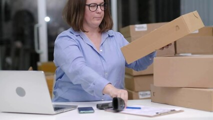 Poster - logistic shipping online orders. small business owner packaging items for delivery at her e-commerce office scanning barcodes to track