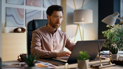 Wall Mural - focused businessman working laptop in office close up. worker surfing internet.