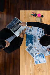 Poster - Top view analyst team discussing financial data on digital dashboard, analyzing chart and graph papers by data science software on wooden table background. Business intelligence and Fintech. Fervent
