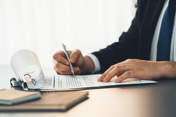 Wall Mural - Businessman signs contract agreement paper or business legal form with trust and professionalism. Closeup of hand holding pen in corporate meeting for official business deal. Equilibrium