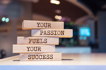 Wooden blocks with words 'Your passion fuels your success'. Inspirational motivational quote.
