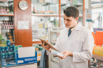 Pharmacist checking Checks Inventory of Medicine, Drugs, Vitamins with tablet and checking patient's prescription in modern pharmacy.