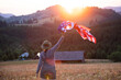Woman with USA flag in magic sunset.