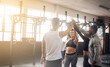 © Chanel M/peopleimages.com - Celebrate, high five and teamwork of people in gym for fitness, team building or solidarity. Collaboration, group of happy friends and celebration for workout targets, goals or support for motivation