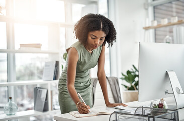 Poster - Computer, planning and business woman writing and working by her desk or table in a corporate startup company. Internet, online and professional female employee or African worker with a schedule book