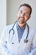 © Cavan Images - Portrait of happy male healthcare worker with stethoscope in clinic