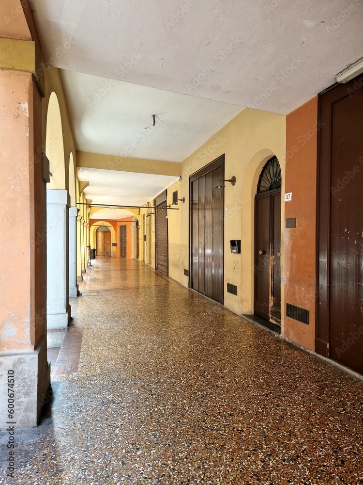Portico in bright yellow or orange (light) colors in Bologna, Italy ...